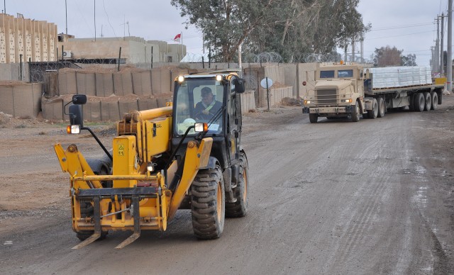 A small convoy of 1174th Transportation Company, 395th Combat Sustainment Support Battalion, 15th Sustainment Brigade, trucks and a civilian contractor forklift delivers upwards of 30,000 bottles of waters to troops and civilians around base here, No...