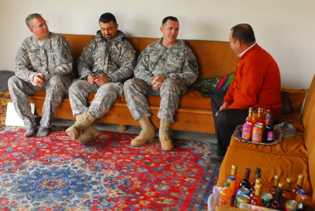 Shwan Tahir Hussein (right), speaks with Lt. Col. Hugh McNeely, the deputy commanding officer of 2nd Brigade Combat Team, 1st Cavalry Division, before receiving money for his new hoop house outside of Kirkuk, Iraq, Nov. 17. A hoop house is a place...