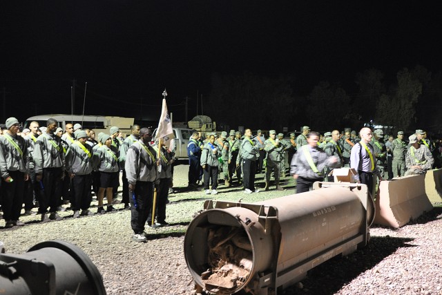 Service members at Contingency Operating Location Q-West, Iraq, wait for the start of the 395th Combat Sustainment Support Battalion's "Shine the Light Walk" here Nov. 20. The walk was intended to raise awareness of sexual assault prevention and...
