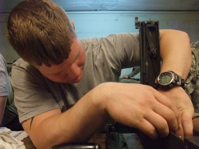 CONTINGENCY OPERATING LOCATION Q-WEST, Iraq - Pfc. William D. Sandford, a Hernando, Miss., native and gun truck driver with A Company, 2nd Battalion, 198th Combined Arms out of Hernando, Miss., cleans an M2 .50 caliber machine gun in the company...
