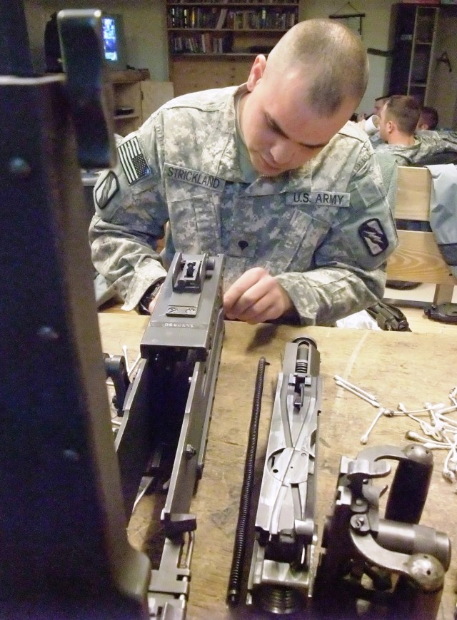 CONTINGENCY OPERATING LOCATION Q-WEST, Iraq - Spc. Justin R. Strickland, a Southaven, Miss., native and vehicle gunner with A Company, 2nd Battalion, 198th Combined Arms out of Hernando, Miss., cleans an M2 .50 caliber machine gun in the company...