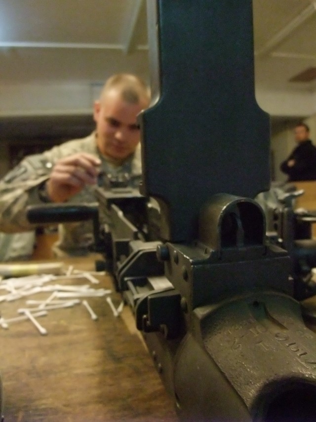 CONTINGENCY OPERATING LOCATION Q-WEST, Iraq - Spc. Justin R. Strickland, a Southaven, Miss., native and vehicle gunner with A Company, 2nd Battalion, 198th Combined Arms out of Hernando, Miss., cleans an M2 .50 caliber machine gun in the company...