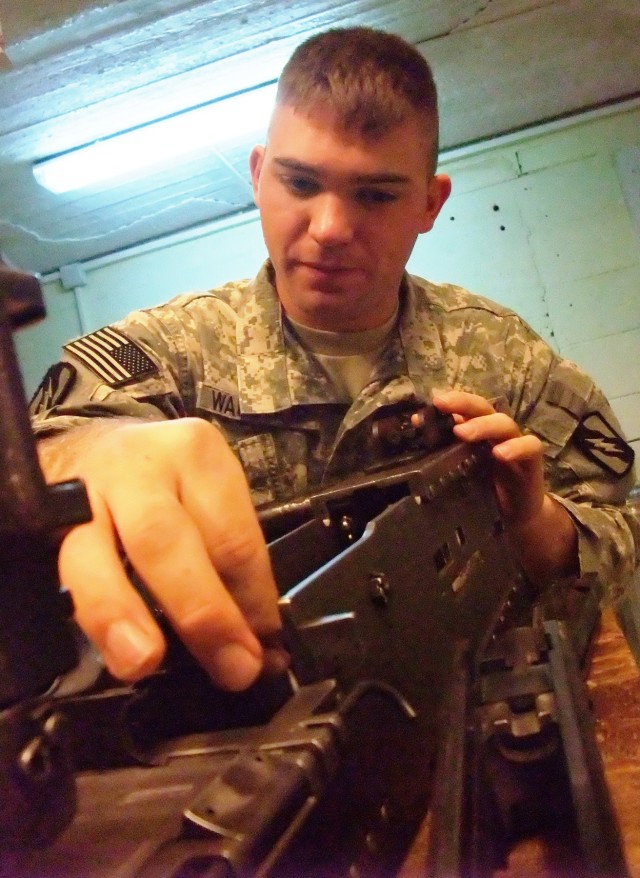 CONTINGENCY OPERATING LOCATION Q-WEST, Iraq - Spc. William B. Waldrop, a Senatobia, Miss., native and gun truck driver with A Company, 2nd Battalion, 198th Combined Arms out of Hernando, Miss., cleans an M2 .50 caliber machine gun in the company...