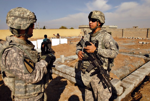 First Lieutenant Bryan Riggs (left), from Stanton, Ky., and a platoon leader in 1st Battalion, 8th Cavalry Regiment, 2nd Brigade Combat Team, 1st Cavalry Division, and Sgt. 1st Class Raymond Loriaux (right), from San Antonio with U.S. Army Civil Affa...