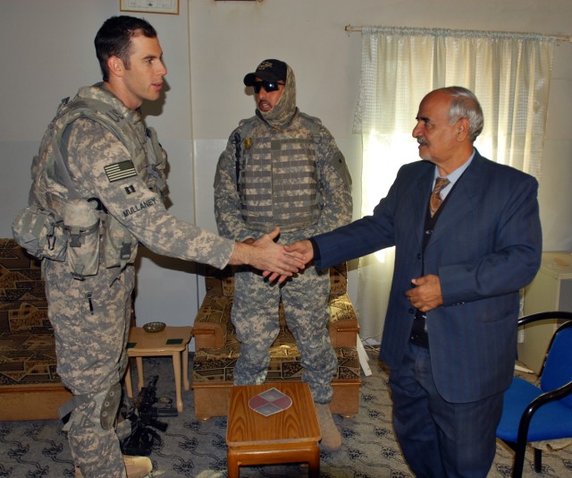 Captain Brennan Mullaney (left), from Cumberland, Md., and commander of Troop B, 4th Squadron, 9th Cavalry Regiment, 2nd Brigade Combat Team, 1st Cavalry Division, meets with Mayor Talib of Taza, Iraq, Nov. 24. According to Capt. Mullaney, 22...