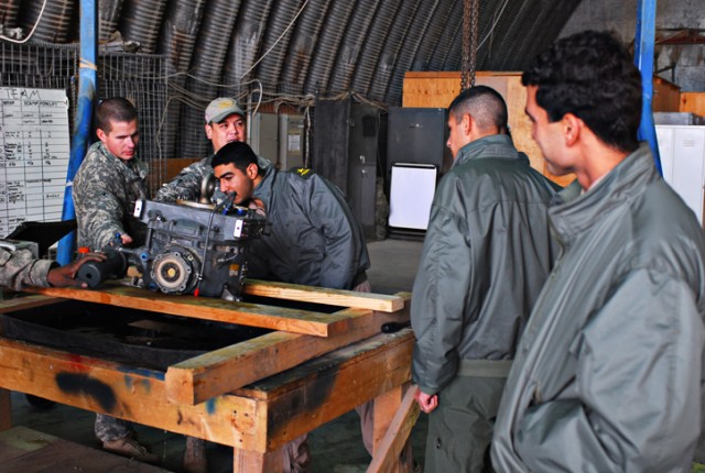 An Iraqi Air Force student training to become a helicopter pilot gets a close look at some of the mechanics of U.S. helicopters during a visit with pilots from 2nd Squadron, 9th Cav. Regt., Aviation Brigade of the 25th Infantry Division, on...