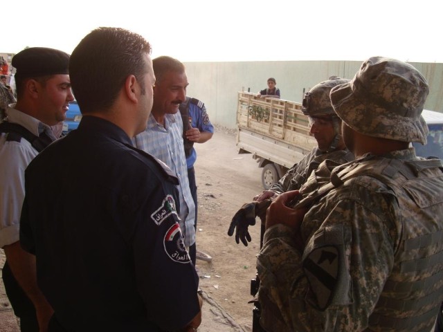 An environmental police officer and a representative from the Belladiya speak to 1st Lt. Danesh Kateli, an Orlando, Fla., native and a platoon leader with 2nd Brigade Combat Team, 1st Cavalry Division, Nov. 21. The environmental police officers super...