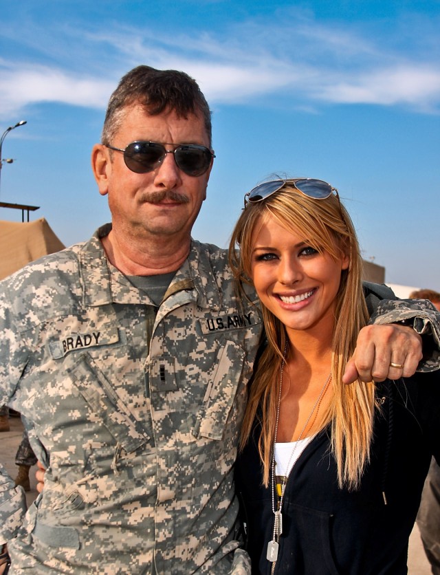 CAMP TAJI, Iraq- Chief Warrant Officer 3 Charles Brady (left), from Harker Heights, Texas, a UH-60 Black Hawk pilot in 1st Air Cavalry Brigade, 1st Cavalry Division, stands next to his daughter Heather Brady after being reunited, here, Nov. 27. Heath...