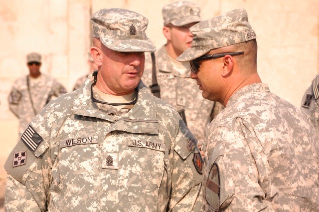 CAMP TAJI, Iraq - Command Sgt. Maj. Lawrence Wilson (left), the senior non commissioned officer of Multi-National Force-Iraq, speaks with Corpus Christi, Texas native, 1st Sgt. Johnny Escamilla, of 1st Brigade Combat Team, 1st Cavalry Division, speak...