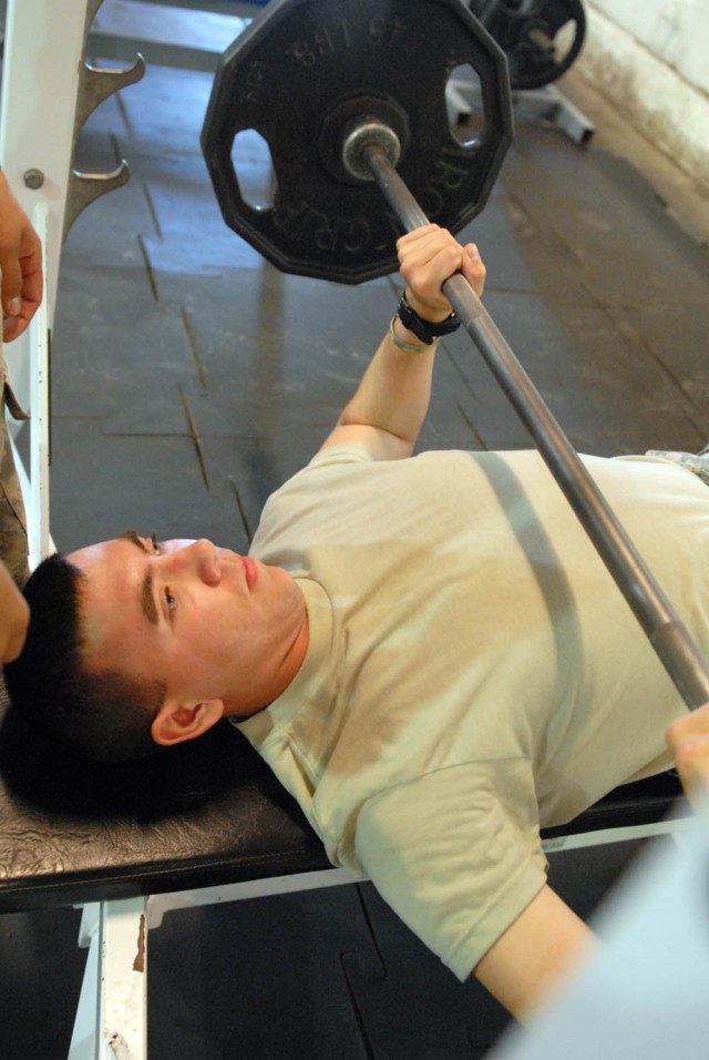 CAMP TAJI, Iraq - Nanuet, N.Y. native, Spc. Peter Monroe, a tanker assigned to Company D, 2nd Battalion, 8th Cavalry Regiment, 1st Brigade Combat Team, 1st Cavalry Division, executes the bench press, an exercise designed to improve the strength of...