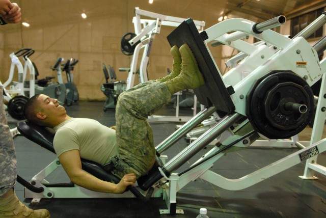 CAMP TAJI, Iraq - Snellville, Ga. native, Pfc. Micah Rousseau, a tanker assigned to Company D, 2nd Battalion, 8th Cavalry Regiment, 1st Brigade Combat Team, 1st Cavalry Division, performs the linear hack press to strengthen his thighs, at the Air...