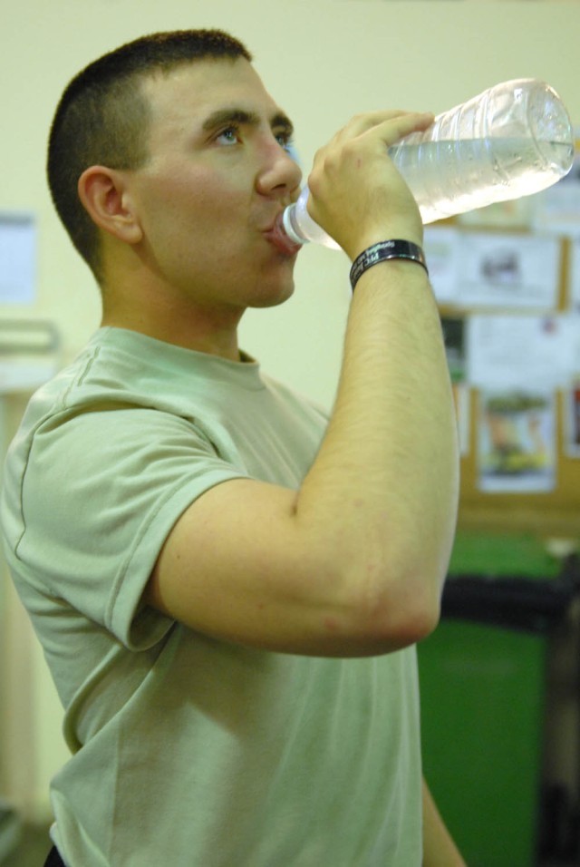 CAMP TAJI, Iraq - Nanuet, N.Y. native, Spc. Peter Monroe, a tanker assigned to Company D, 2nd Battalion, 8th Cavalry Regiment, 1st Brigade Combat Team, 1st Cavalry Division, hydrates after a hard workout at the Air Cavalry Gymnasium on Camp Taji,...