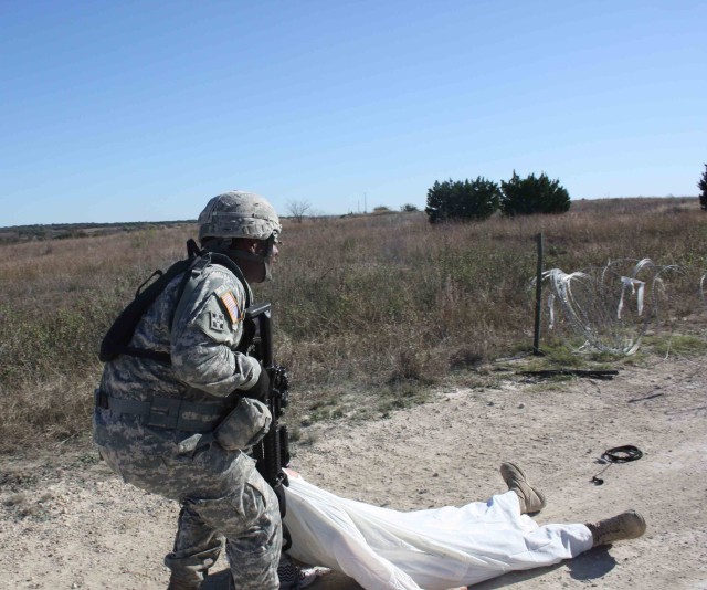 Staff Sgt. Sidney, Lintuan, assigned to Company B, 2nd Battalion, 12th Cavalry Regiment, 4th Brigade Combat Team, 1st Cavalry Division pulls and enemy combatant to safety during Expert Infantry Badge testing Nov. 23. Lintuan was one of 14 Soldiers...