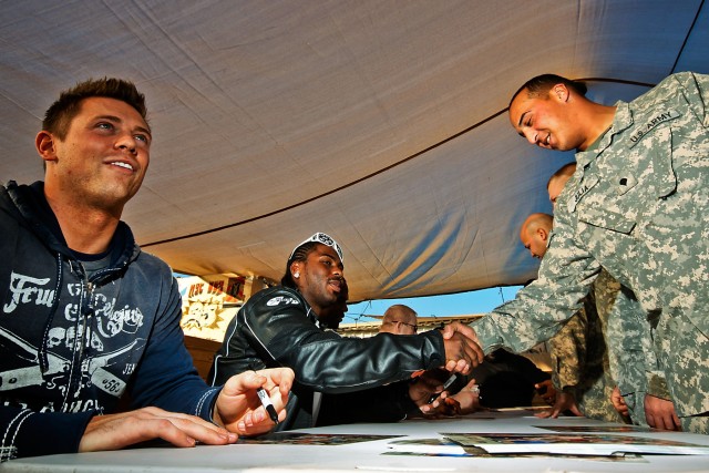 CAMP TAJI, Iraq-World Wrestling Entertainment superstars Mike 'The Miz' Mizanin (left) and JTG (center), sign autographs with Soldiers from the 615th Aviation Support Battalion,1st Air Cavalry Brigade, 1st Cavalry Division, here, Dec. 2, as part...