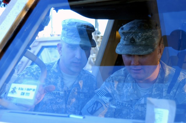 CONTINGENCY OPERATING LOCATION Q-WEST, Iraq - Lt. Col. Kerry Goodman (left), a native of Meridian, Miss., and commander of 2nd Battalion, 198th Combined Arms out of Senatobia, Miss., chats Staff Sgt. Robert E. Cullom, a scout truck commander from...