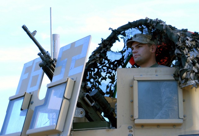 CONTINGENCY OPERATING LOCATION Q-WEST, Iraq - Pfc. Robert S. Lacey, a native of Houston, Miss., and gunner with 1st Platoon, B Company, 2nd Battalion, 198th Combined Arms, out of Greenwood, Miss., performs a pre-combat check on his M240B machine...