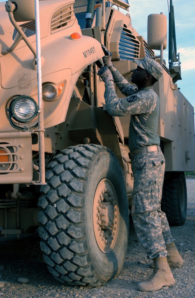 CONTINGENCY OPERATING LOCATION Q-WEST, Iraq - Pfc. Derrell A. Pittman, a Greenville, Miss., native and gun truck driver, performs preventative maintenance, checks, and services on his Caimen version of the Mine-Resistant, Ambush-Protected vehicle....