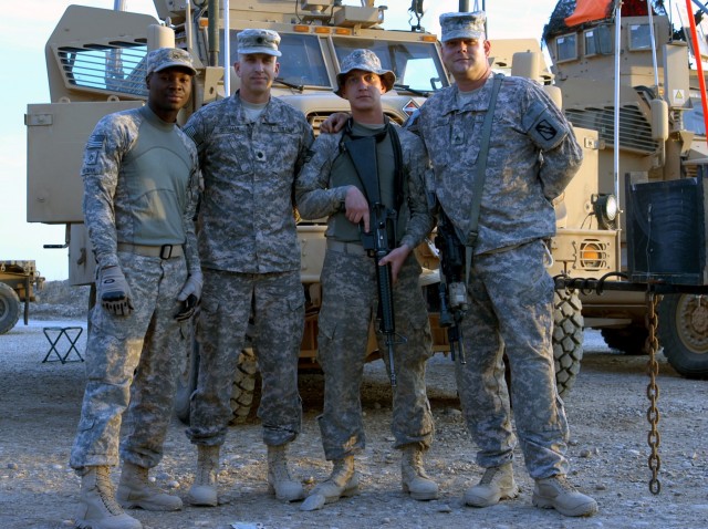 CONTINGENCY OPERATING LOCATION Q-WEST, Iraq - The battalion commander poses with his gun truck crew. Lt. Col. Kerry Goodman (second from left), a Meridian native commanding 2nd Battalion, 198th Combined Arms out of Senatobia, Miss., stands with...