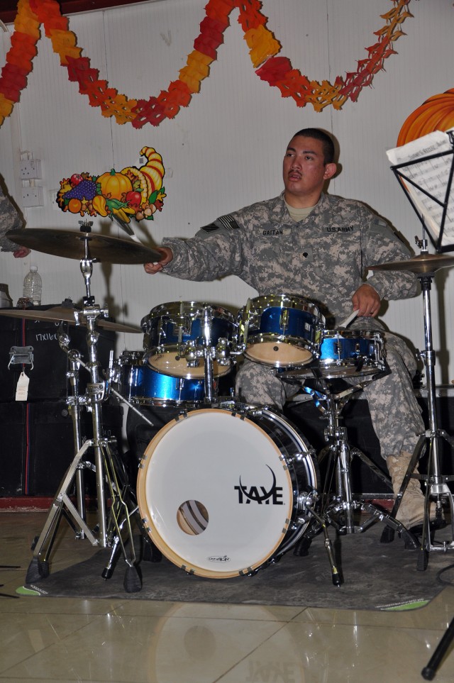 Spc. Eisner Gaitain, 3rd Infantry Division bandsmen, plays Christmas music on his drums with the 3rd Infantry Division's The Marne Jazz Ensemble in the dining facility here Nov. 26 as part of the Thanksgiving festivities. (U.S. Army photo by Sgt....