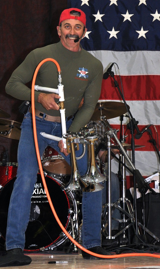 Country music singer and Pensacola, Fla., native, Aaron Tippin prepares to sound a semitrailer horn rigged to a portable air compressor at a concert for the troops at the Morale Welfare and Recreation tent here, Nov. 27. (U.S. Army photo by Sgt. Matt...