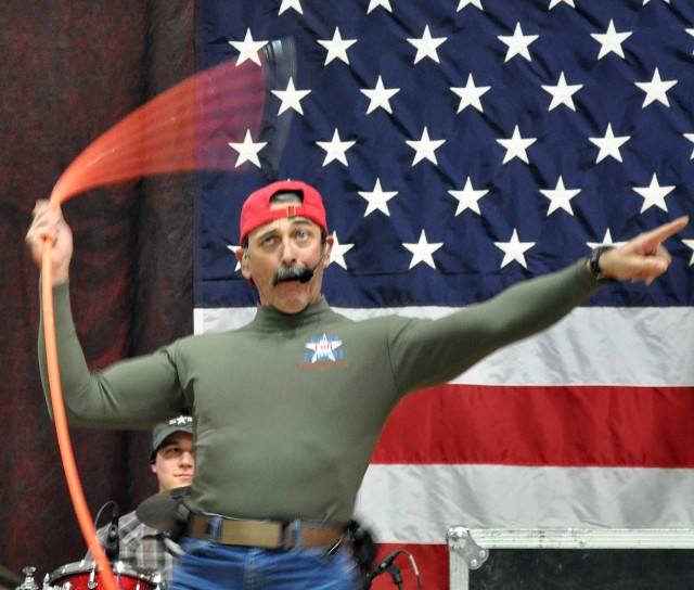 Country music singer and Pensacola, Fla., native, Aaron Tippin swings an air hose used to sound a semitrailer horn at a concert for the troops at the Morale Welfare and Recreation tent here, Nov. 27. (U.S. Army photo by Sgt. Matthew C. Cooley,...