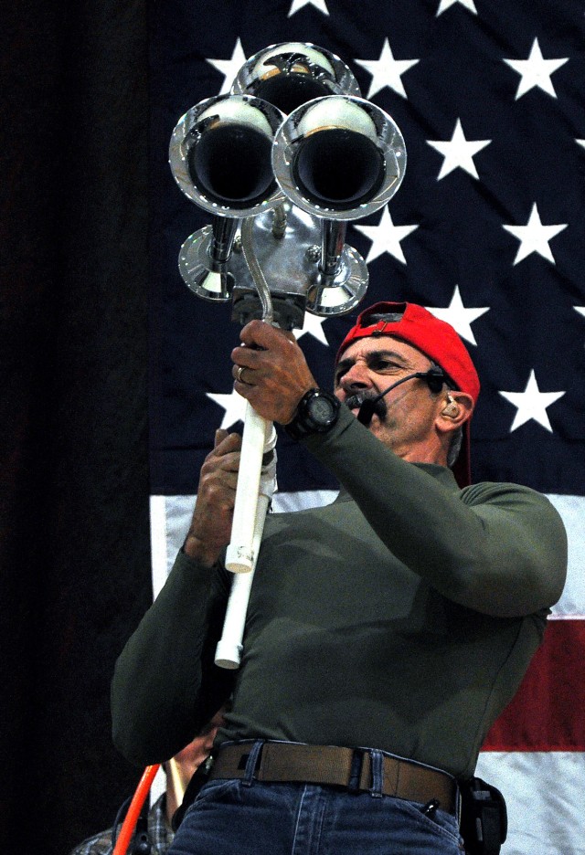 Country music singer and Pensacola, Fla., native, Aaron Tippin sounds a semitrailer horn rigged to a portable air compressor at a concert for the troops at the Morale Welfare and Recreation tent here, Nov. 27. (U.S. Army photo by Sgt. Matthew C. Cool...