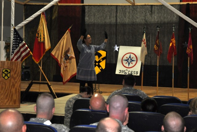 Sgt. Vernita Bunyan, with the 395th Combat Sustainment Support Battalion, demonstrates the Yup'ik Eskimo dance at the Contingency Operating Location Q-West Morale, Welfare and Recreation building Nov. 27 as a part of the Q-West Native American...
