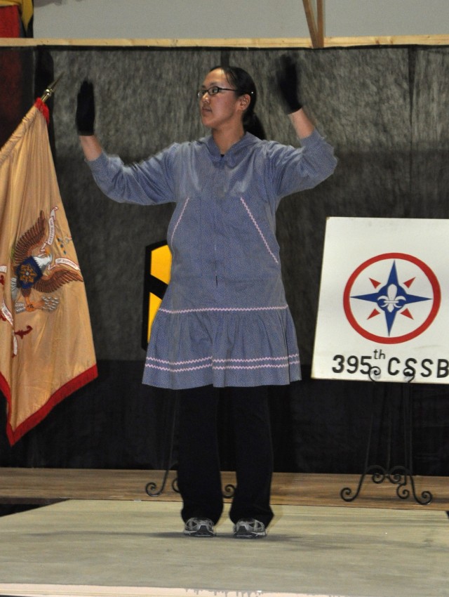 Sgt. Vernita Bunyan, with the 395th Combat Sustainment Support Battalion, demonstrates the Yup'ik Eskimo dance at the Contingency Operating Location Q-West Morale, Welfare and Recreation building Nov. 27 as a part of the Q-West Native American...