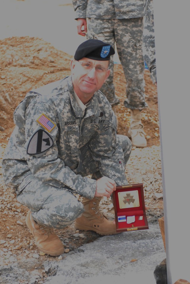 Fort Irwin/National Training Center Commanding General Brig. Gen. Robert "Abe" Abrams displays the memorabilia, which will be embedded at the base of the flag pole of the new NTC Headquarters Building at Fort Irwin, Calif. on Dec. 11, 2009. The...