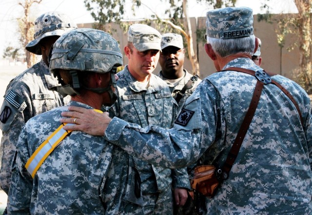 CONTINGENCY OPERATING LOCATION Q-WEST, Iraq - Brig. Gen. William L. Freeman, Jr. (right, back turned), the adjutant general of the Mississippi National Guard, speaks with Soldiers of C Company, 2nd Battalion, 198th Combined Arms, out of Oxford, Miss....
