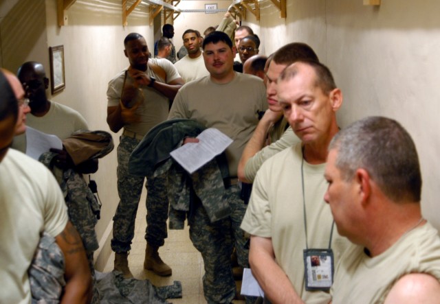 Soldiers with 2nd Battalion, 198th Combined Arms, a Mississippi Army National Guard unit out of Senatobia, Miss., stand in line for H1N1 flu vaccinations Nov. 28 at the base defense operations center at Contingency Operating Location Q-West, Iraq....
