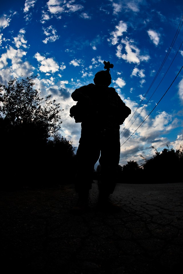 TAJI, Iraq -A Soldier from 3rd Battalion, 227th Aviation Regiment, 1st Air Cavalry Brigade, 1st Cavalry Division, waits for an approaching vehicle to stop at a traffic control point, here, Dec. 12. The Air Cav. Soldiers partnered with the 34th...