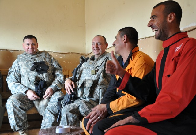 Iraqi pump house workers laugh as Col. Larry Phelps, the 15th Sustainment Brigade, 13th Sustainment Command (Expeditionary), commander, tells humorous stories during a visit to the pump house on the Tigris River in Al Qayyarah, Iraq, Dec. 1. (U.S....