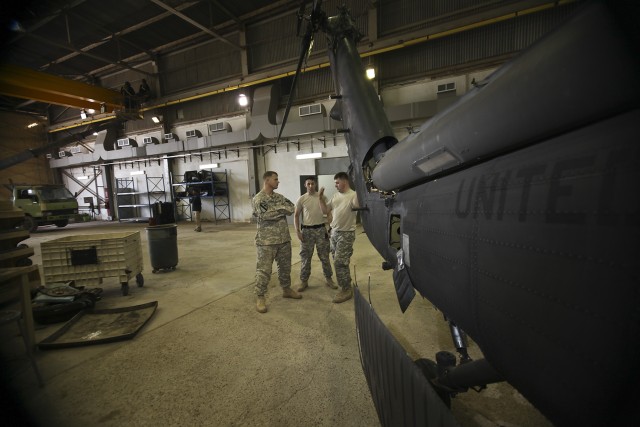 CAMP TAJI, Iraq – To find out about issues with the current UH-60 Black Hawk helicopter phase, Chief Warrant Officer 5 Shawn Marrin (left), from Lantana, Fla., the maintenance test pilot section chief talks with Black Hawk mechanics Spc. Casey...