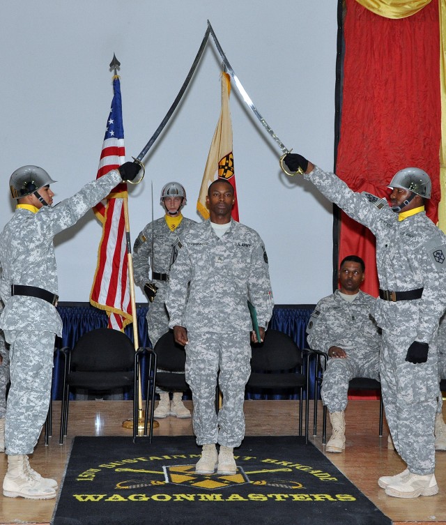Sgt. Joseph Cooperwood, an orderly sergeant for Headquarters and Headquarter Company, 15th Special Troops Battalion, is presented to the audience as a new member of the Corps of Noncommissioned Officers at an NCO induction ceremony in the Morale...