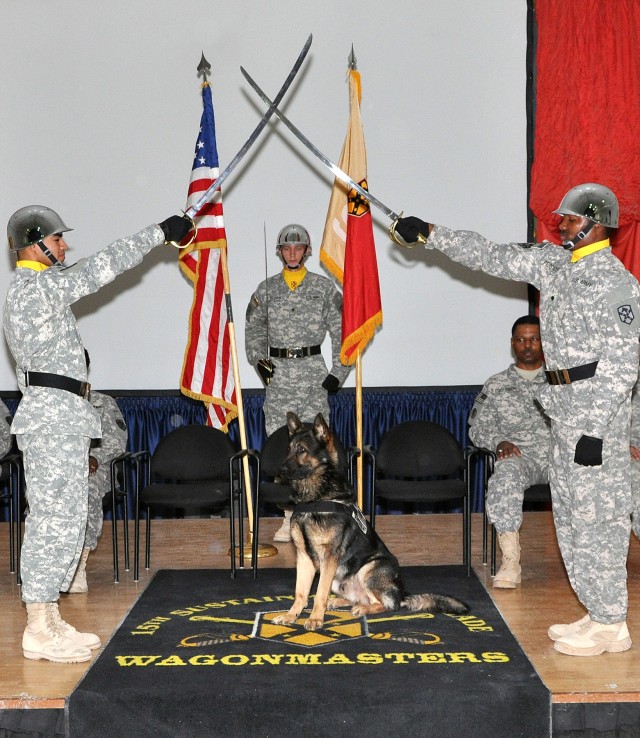 Sgt. 1st Class Rex, a patrol explosive detector dog for the 178th Military Police Detachment, is presented to the audience as a new member of the Corps of Noncommissioned Officers at an NCO induction ceremony in the Morale Welfare and Recreation...