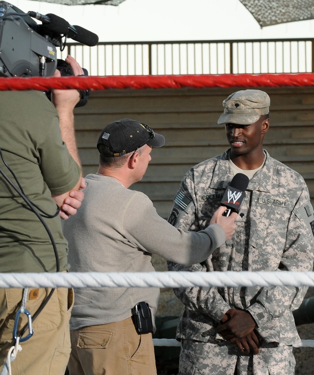 Spc. Quinton L. Coleman, a cargo specialist with the 159th Seaport Operations Company, 80th Ordnance Battalion, 15th Sustainment Brigade, 13th Sustainment Command (Expeditionary), is interviewed by World Wrestling Entertainment staff after singing...