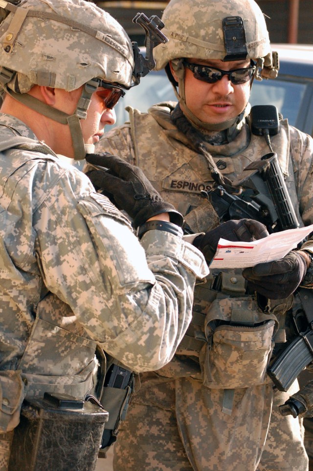 TAJI, Iraq - Redding, Calif. native, Staff Sgt. Jereme Espinosa (right), an armor crewman assigned to Company C, 2nd Battalion, 8th Cavalry Regiment, 1st Brigade Combat Team, 1st Cavalry Division, shows a map to Mt. Olivet, Ky. native, Staff Sgt. Car...