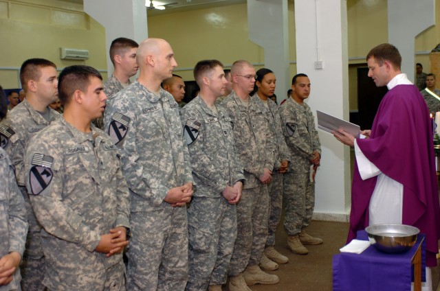 CAMP TAJI, Iraq- Six service members from the 1st Air Cavalry Brigade listen attentively in the front row as Chaplain (Maj.) Tyson Wood (right), from Long Beach Island, N.J., administers their final vows in confirming them as Catholics, in a...