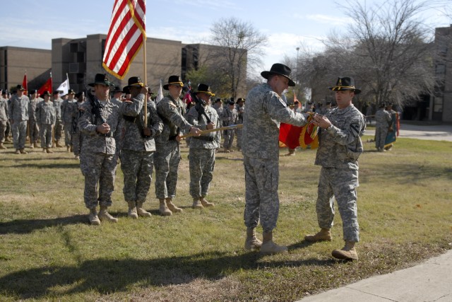 Col. Gary Volesky and Command Sgt. Major James Pippin uncase the colors of 3rd Heavy Brigade Combat Team, 1st Cavalry Division in a ceremony in front of the brigade's headquarters Dec. 15. The uncasing symbolizes the unit's resumption of command...