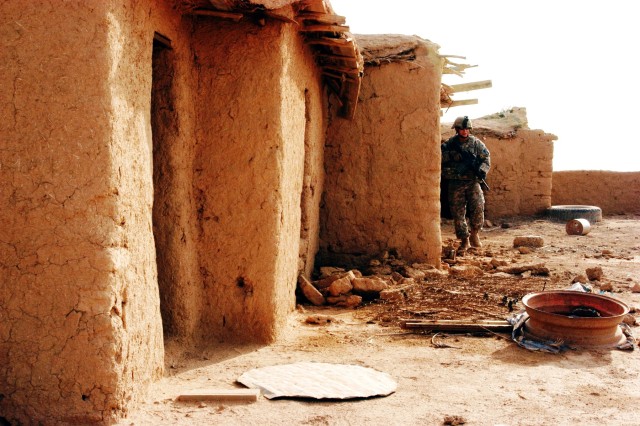 CONTINGENCY OPERATING LOCATION Q-WEST, Iraq - Sgt. Patrick A. Martin, a force protection company truck commander from Southaven, Miss., reconnoiters buildings in an abandoned village near Contingency Operating Location Q-West during a presence...