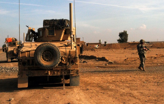 CONTINGENCY OPERATING LOCATION Q-WEST, Iraq - Gun trucks of the Contingency Operating Location Q-West force protection company park on the outskirts of Ejbah, a small village near base during a presence patrol Dec. 15. The Soldiers belong to 1st...