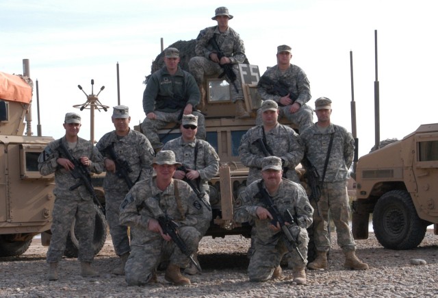 CONTINGENCY OPERATING LOCATION Q-WEST, Iraq - Mississippi Army National Guard members of the force protection company pose near the Base Defense Operations Center, Contingency Operating Location Q-West, Dec. 16. The Soldiers belong to 1st Squad,...