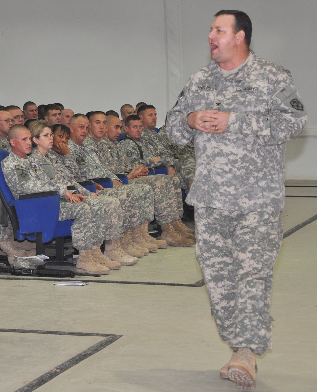 Col. Larry Phelps, 15th Sust. Bde. commander and Greenville, Ala., native, speaks to a group of Soldiers gathered to witness the awarding of the Purple Heart to Staff Sgt. Justin Taylor, a Lancaster, Pa., native and assistant platoon sergeant for the...