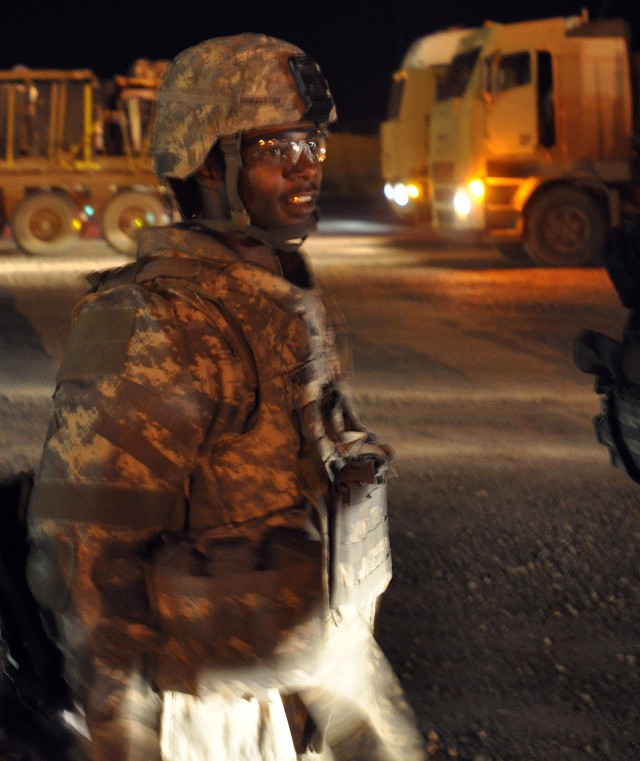 Sgt. Tory Houston, a Monroeville, Ala., native and truck driver for the 40th Trans. Co., does his duty as convoy commander by inspecting Soldiers going on a convoy mission here Dec. 28, to turn in excess equipment at Contingency Operating Location Sp...