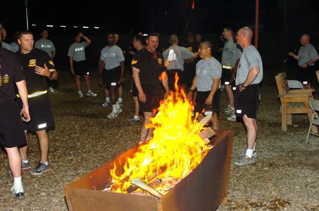 CAMP TAJI, Iraq- A burn barrel provides warmth for senior noncommissioned officers of the 1st Air Cavalry Brigade, 1st Cavalry Division, following a fun run to bring in the New Year, here, Dec. 31. Both sergeants major and first sergeants ran togethe...