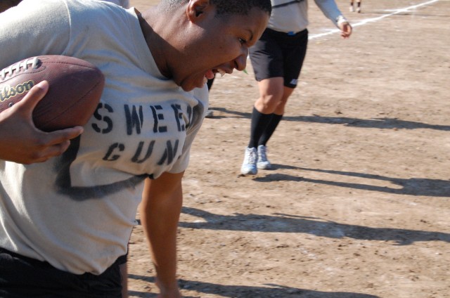 CAMP TAJI, Iraq -Ft. Worth, Texas native Spc. Kanedria Wilson, a petroleum fuel specialist for 4th Battalion, 227th Aviation Regiment, 1st Air Cavalry Brigade, 1st Cavalry Division avoids the sideline during the Powder Puff Football Tournament on New...