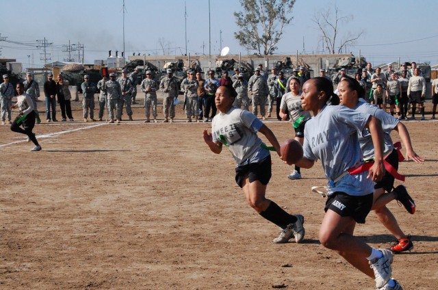 CAMP TAJI, Iraq - Tampa, Fla. native, Pfc. Jessica Cisero, a supply clerk for Headquarters and Headquarters Company, 1st Brigade Special Troops Battalion, 1st Brigade Combat Team, 1st Cavalry Division, races towards the end zone for a touchdown again...