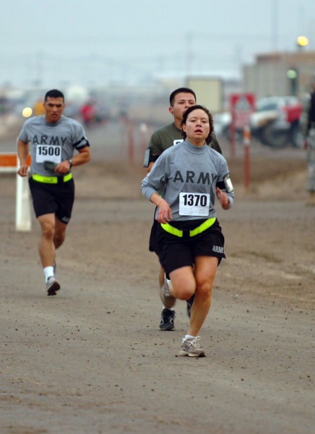 CAMP TAJI, Iraq- Capt. Traci Yamada, from Lakewood, Wash., battalion adjutant, 4th Battalion, 227th Aviation Regiment, 1st Air Cavalry Brigade, 1st Cavalry Division, finishes strongly down the final stretch on her way to winning the women's...