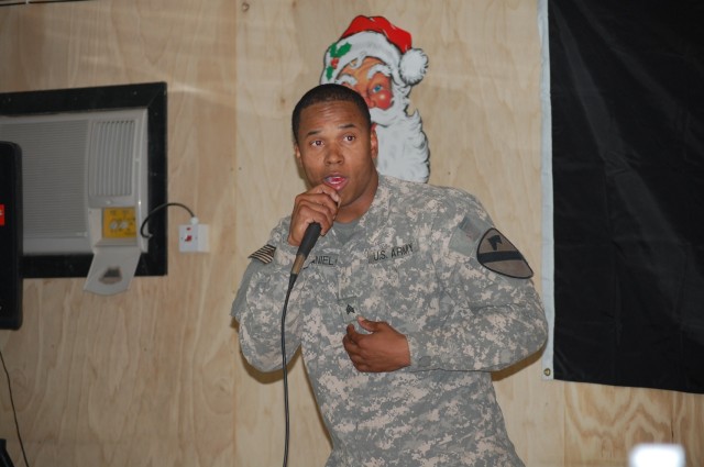 BAGHDAD - Sgt. Taurus "Mack" McDaniel, a cavalry scout from Kountze, Texas, performs his original song, "Mr. Krashtown", during his solo act in a talent show held by the 1st Squadron, 7th Cavalry Regiment, 1st Brigade Combat Team, 1st Cavalry...